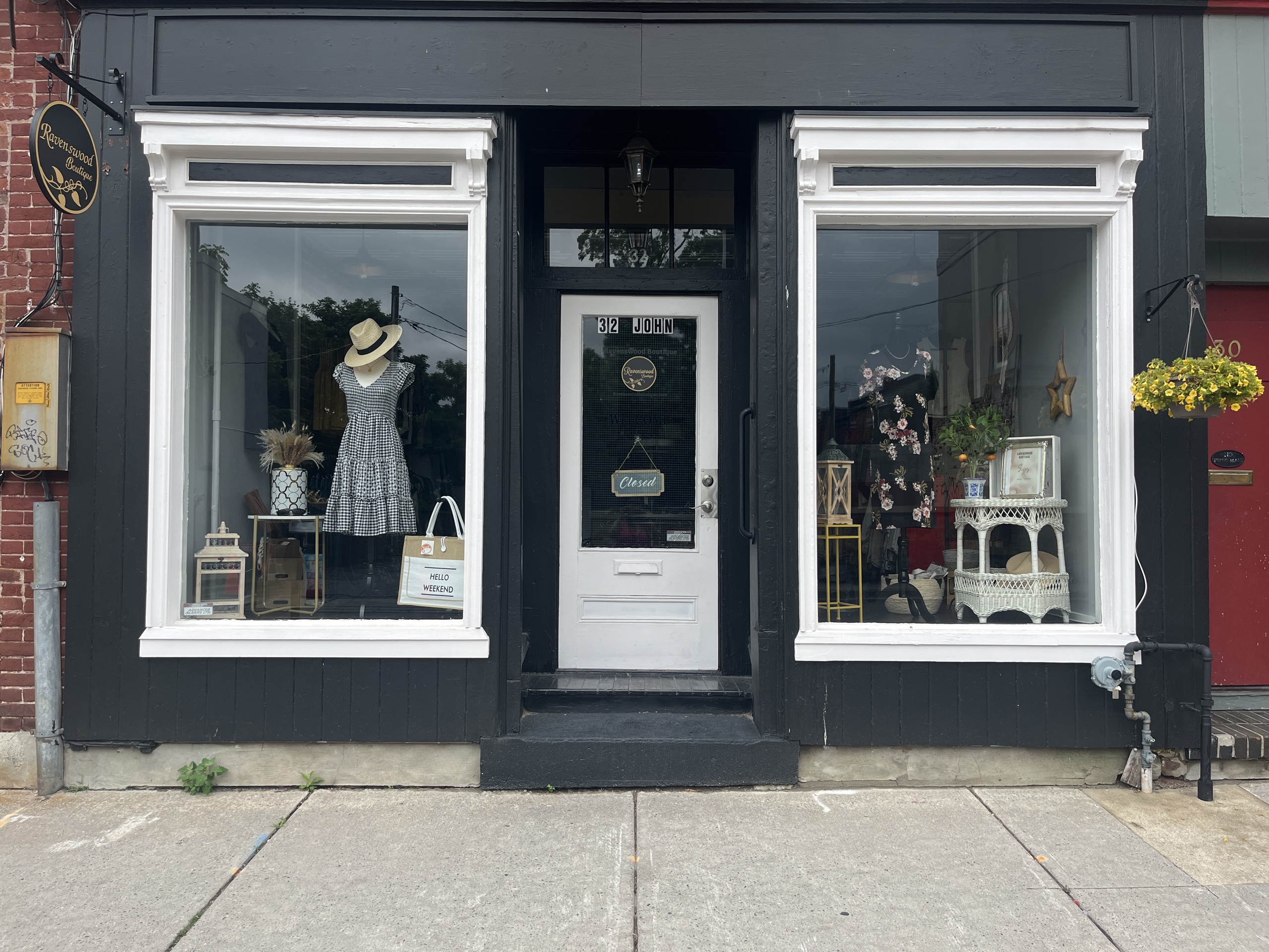 Photo of Ravenswood Boutique store front. Picture features entrance door in the middle with store front windows on both side.