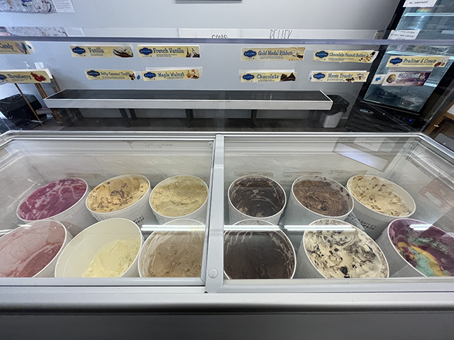 12 ice cream tubs in a large deep freezer.
