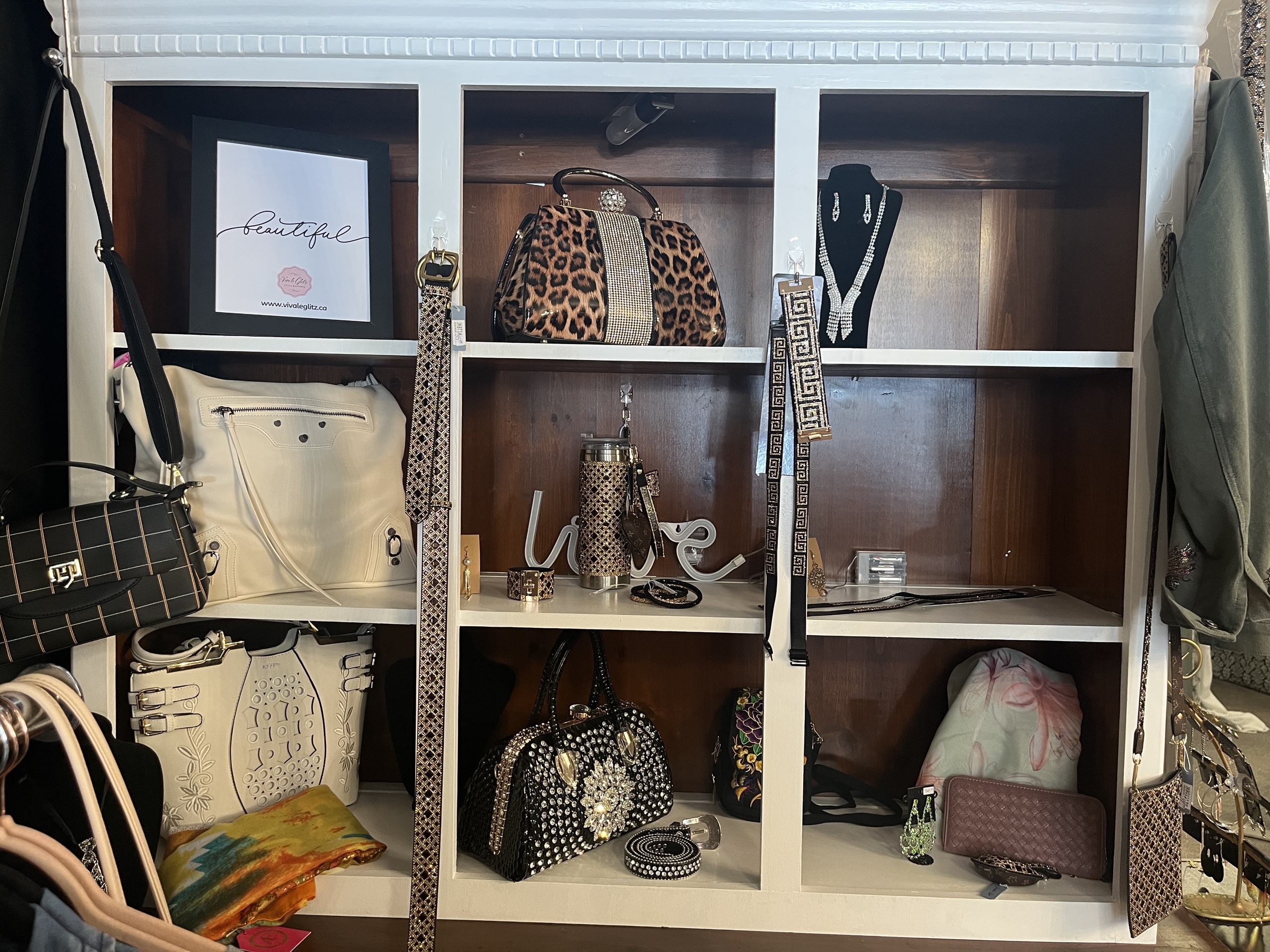 White shelves with bags and other accessories.