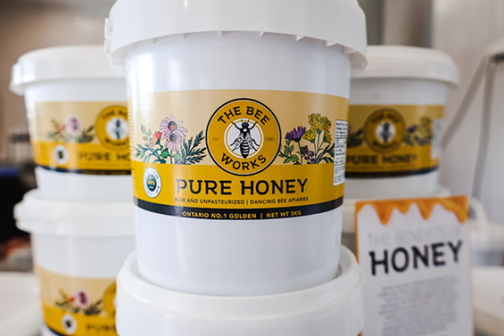 White plastic containers with a yellow label