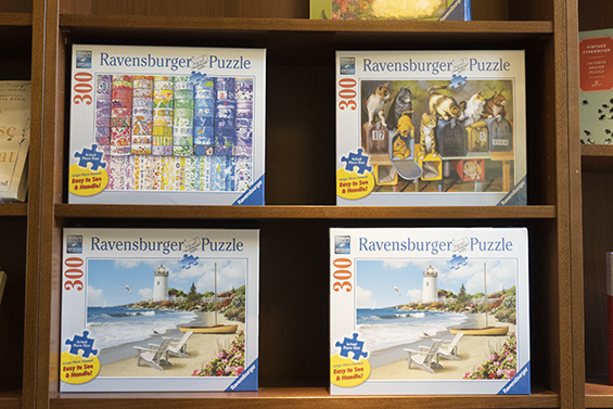 4 puzzles on a shelf.