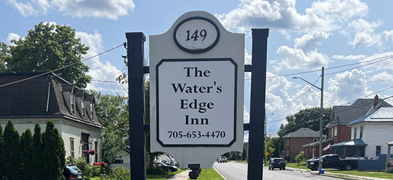 White sign with black writing and framing.