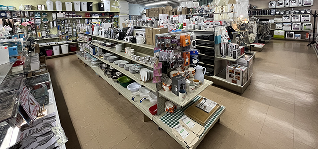 Dishes and kitchen accessories displayed on shelves.