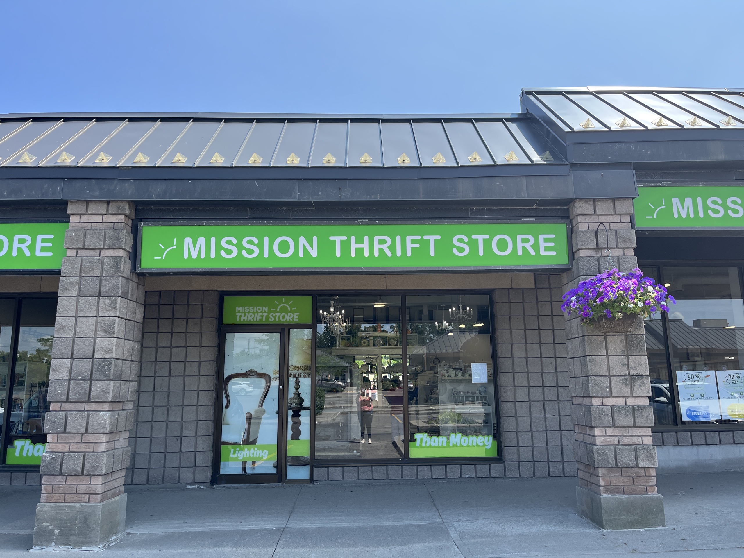 Photo of Mission Thrift Store. Sign above window and entrance reads "Mission Thrift Store."
