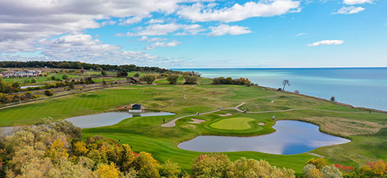 Golf course with multiple ponds beside Lake Ontario.