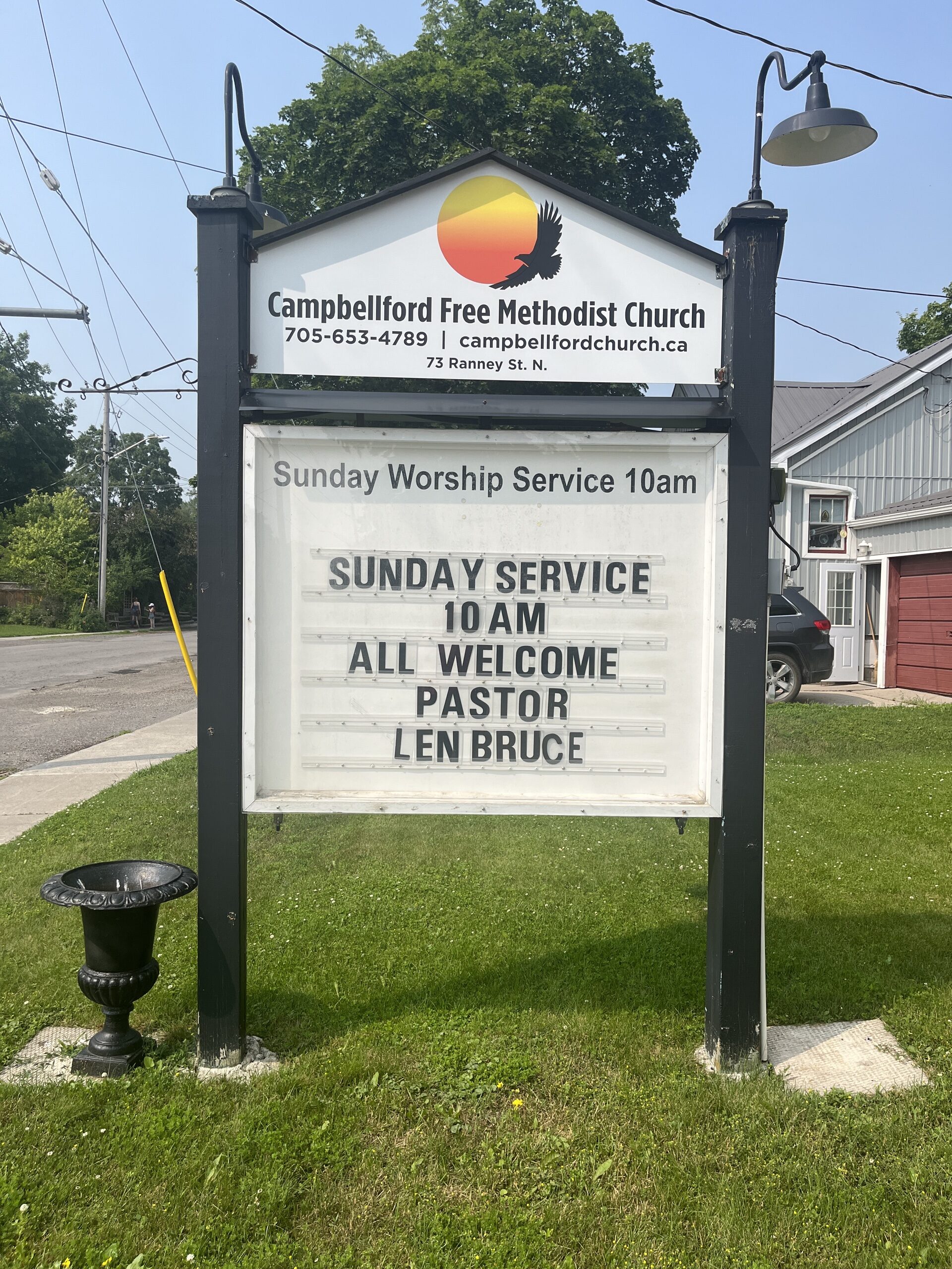 Photo of Campbellford Free Methodist Church sign. Sign reads "Campbellford Free Methodist Church. 7056534789. campbellfordchurch.ca. 73 Ranney St. N. Sunday Worship Service 10am."
