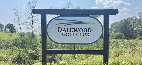 White sign with black wooden frame.