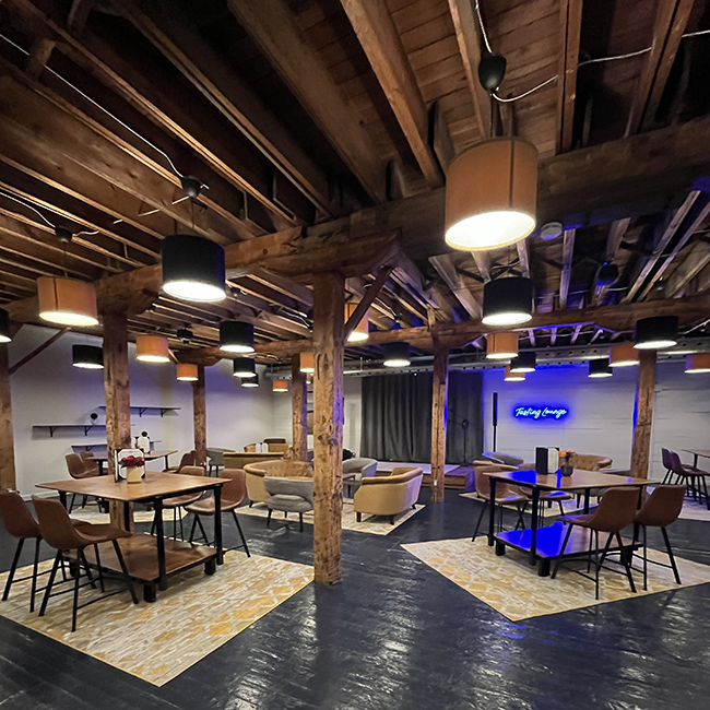 Tables & chairs and lounging areas in front of a stage.