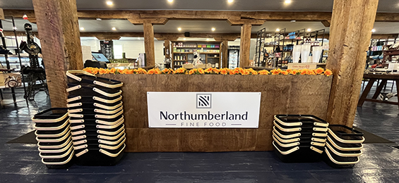 Wooden beams and island with orang flowers and a white sign