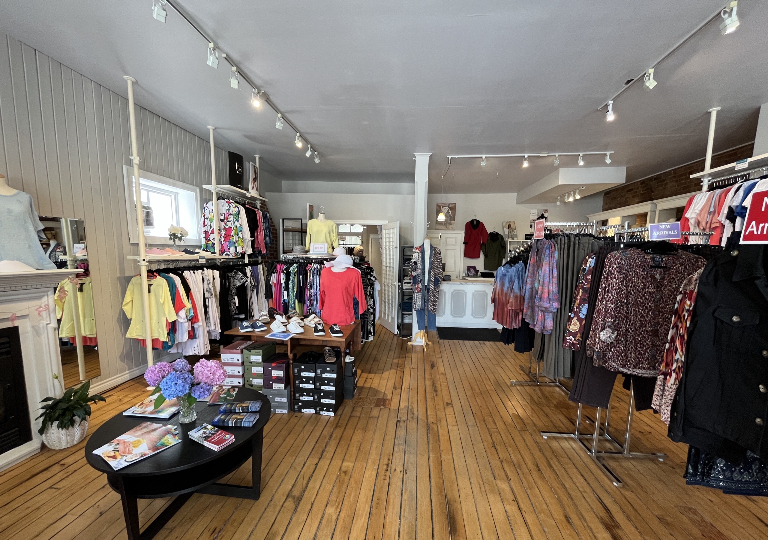 Photo of the stores interior. Clothes hanging on the walls.