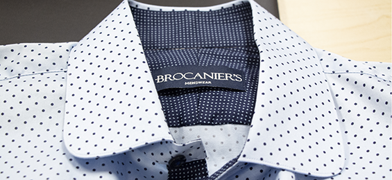 Collar of a white with black polka dots mens dress shirt.
