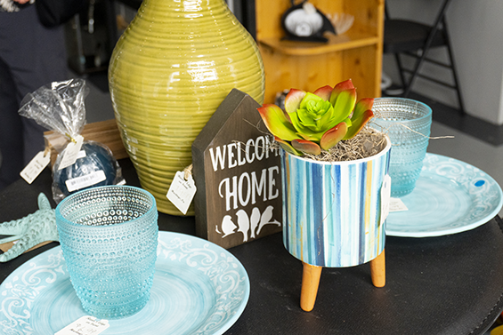 Blue decorative dishware and plants on a table.