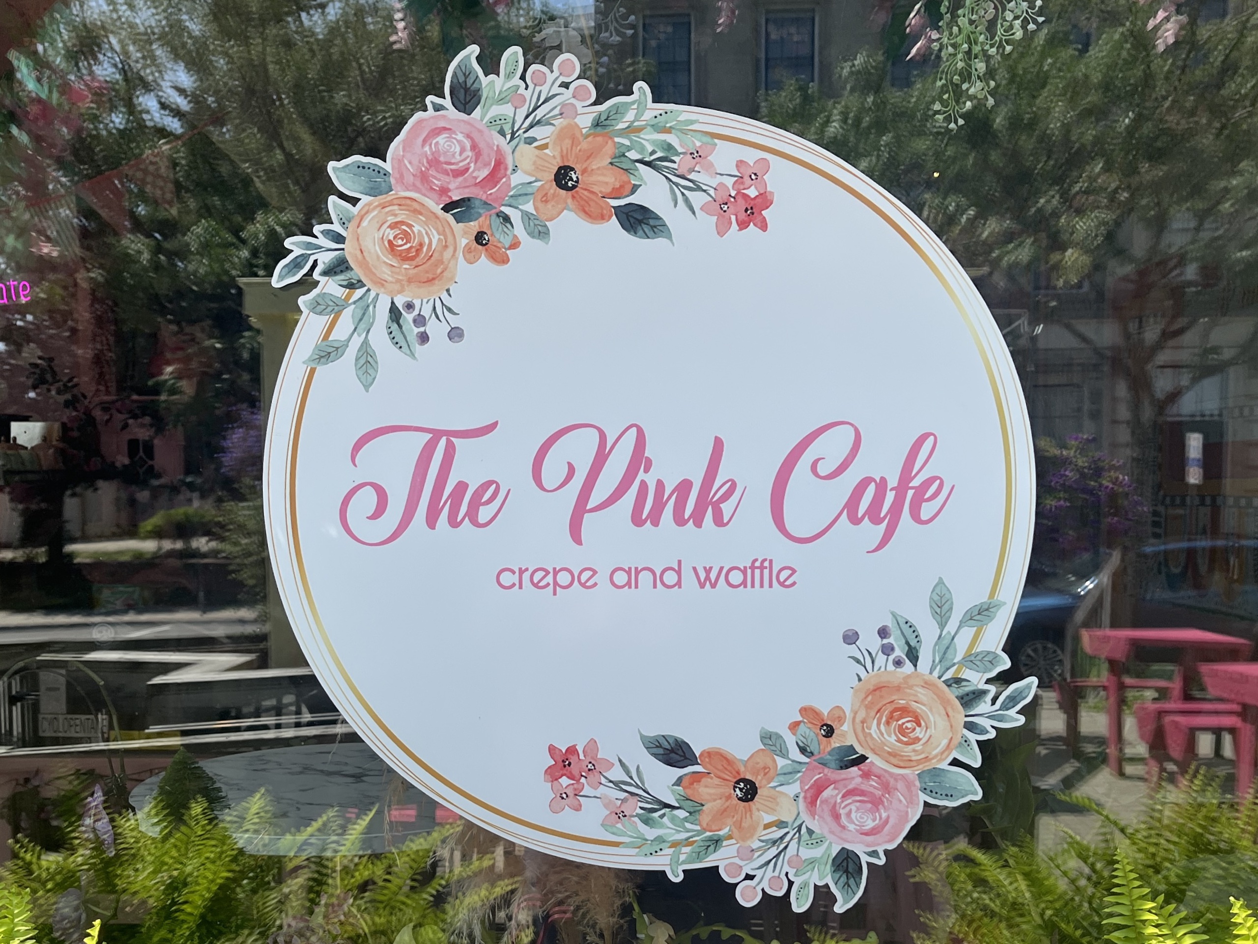 Photo of The Pink Cafe sign. Sign reads "The Pink Cafe crepe and waffle."