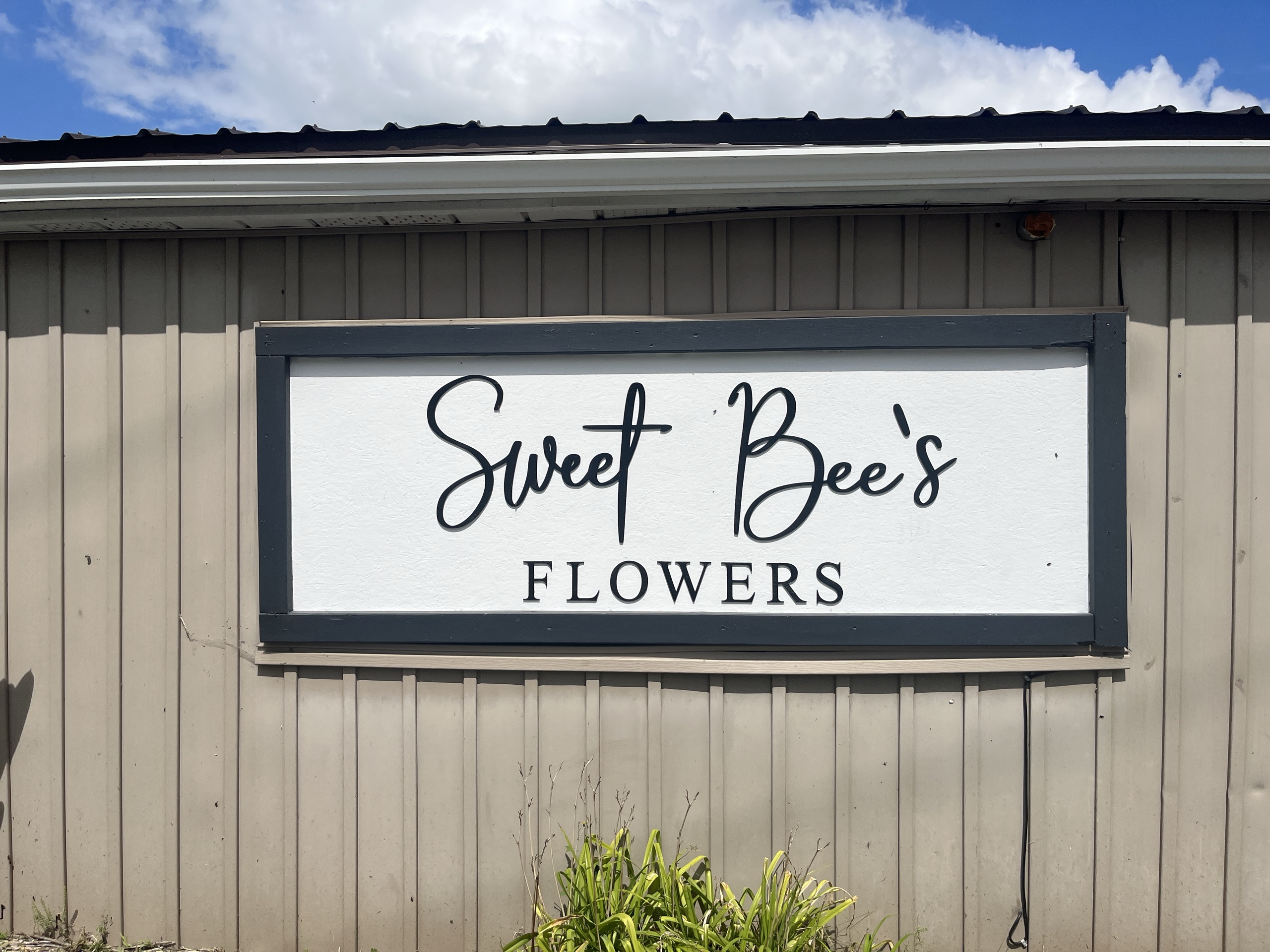 Photo of Sweet Bee's Flowers & Gifts sign. Sign reads "Sweet Bee's Flowers."