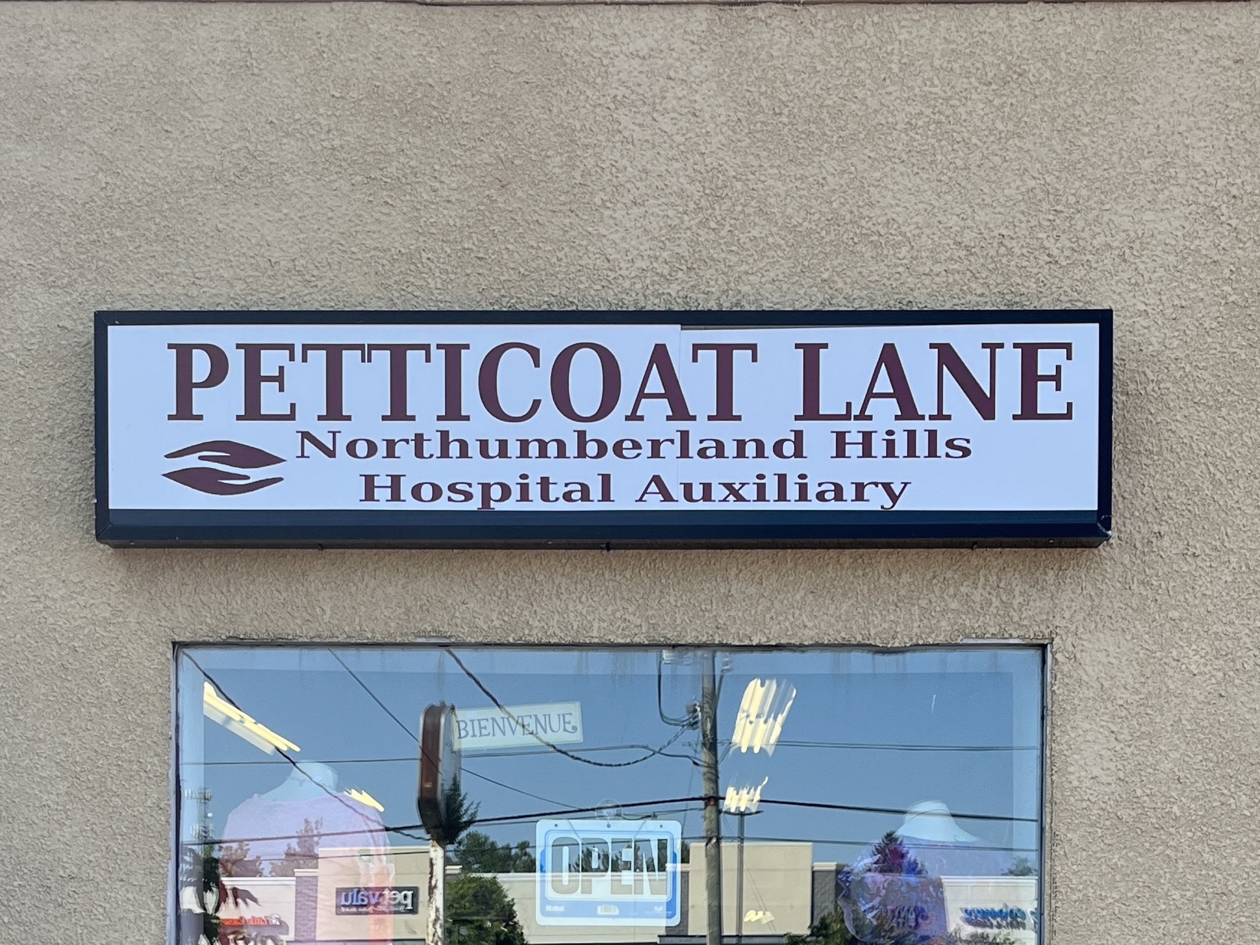 Photo of Petticoat Lane sign. Sign reads "Petticoat Lane. Northumberland Hills Hospital Auxiliary."