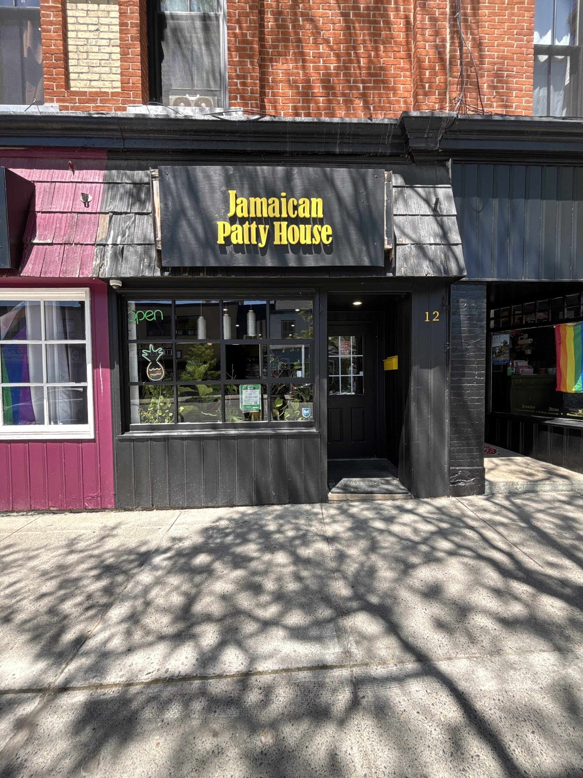 Photo of Jamaican Patty House storefront. Photo features sign reading "Jamaican Patty House" above the window and entrance door.
