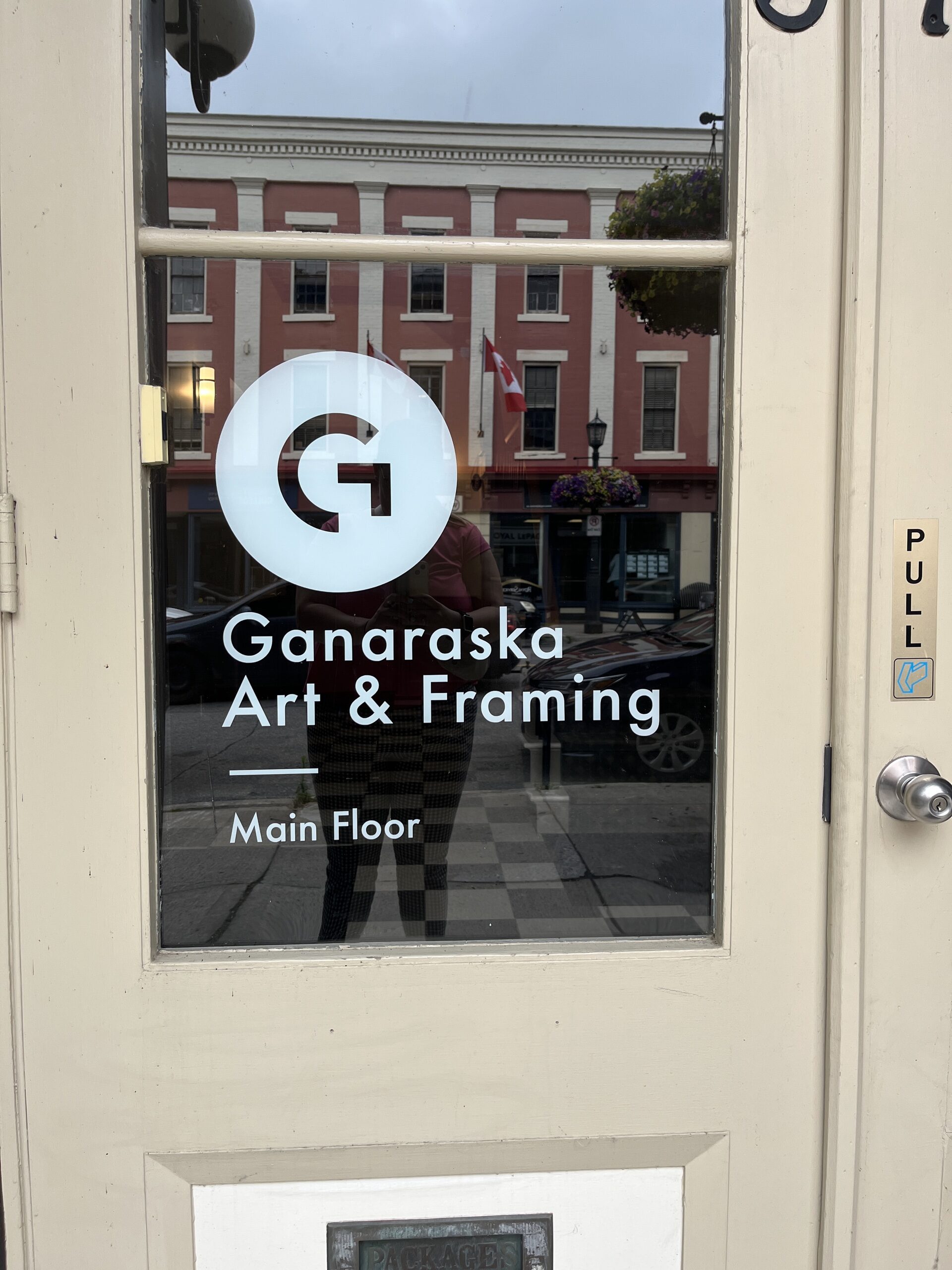 Photo of entrance door to Ganaraska Art & Framing. The writing on the door reads "Ganaraska Art & Framing. Main Floor."
