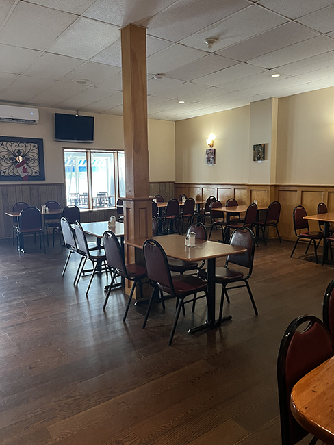Wooden tables with red chairs set in a beige room