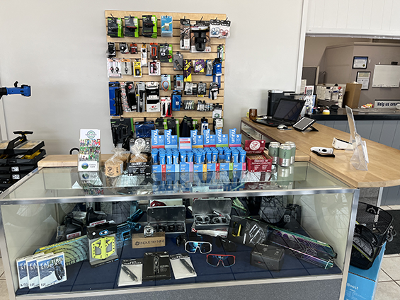 Desk with products for sale and a till.