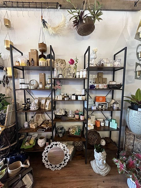 Wooden and black shelf with scented items.