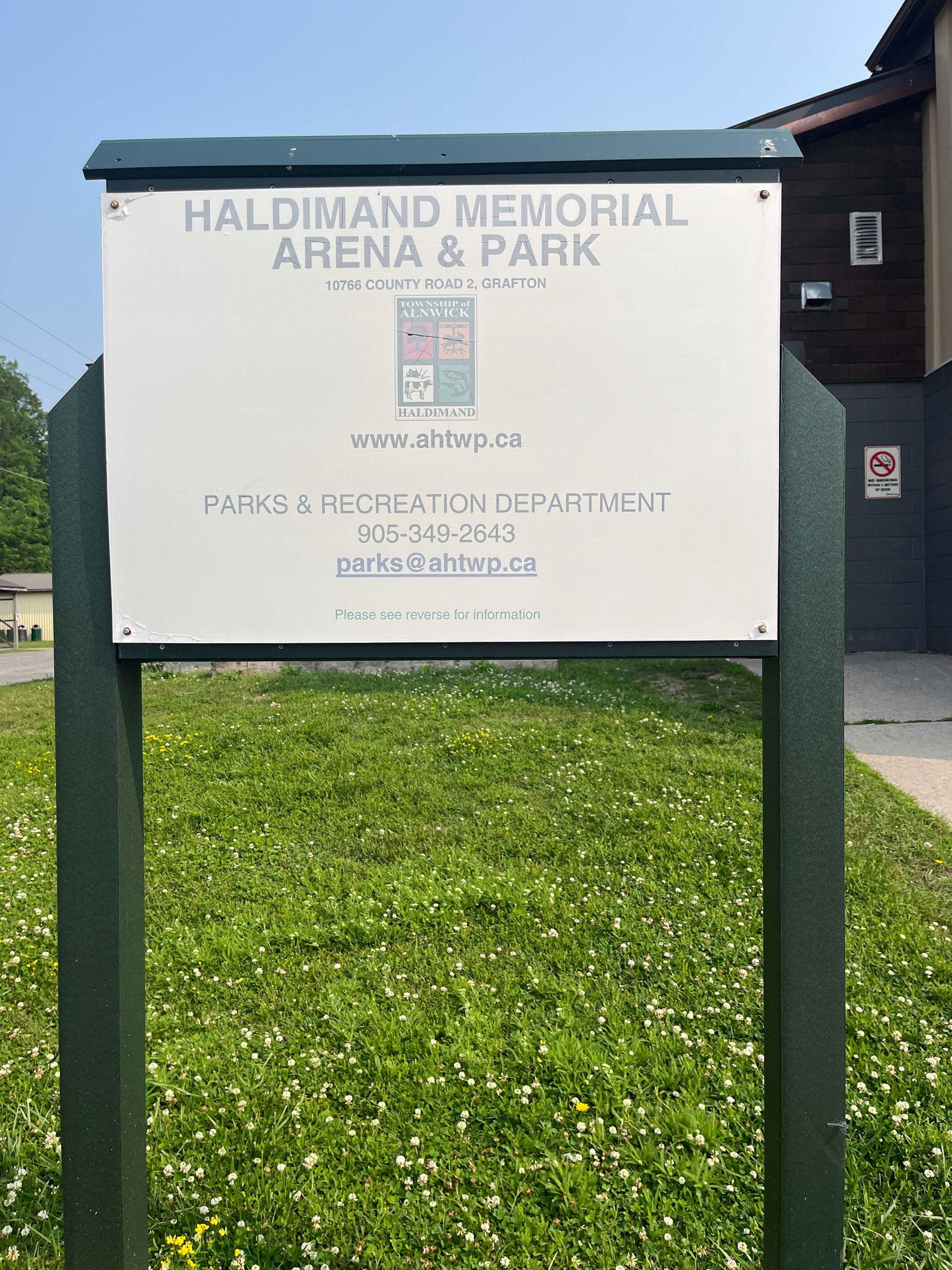 Photo of Haldimand Memorial Arena & Park sign. The sign reads "Haldimand Memorial Arena & Park. 10766 County Road 2, Grafton. www.ahtwp.ca. Parks & Recreation Department 905-349-2643 or parks@ahtwp.ca."