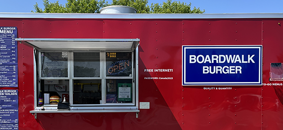 Red Foodtruck with blue sign and an ordering window