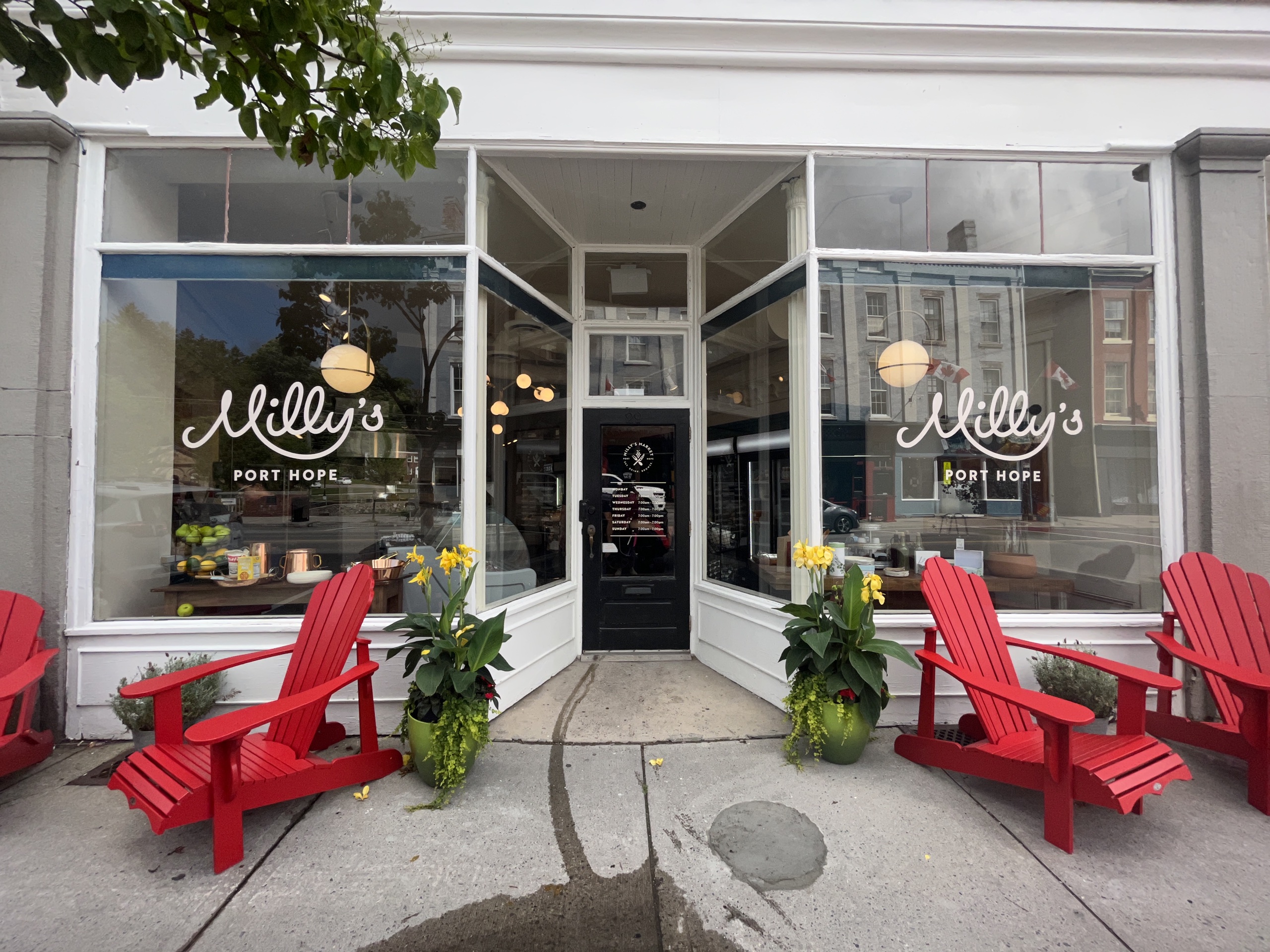 Photo of Milly's Market storefront. Text on the windows read "Milly's Port Hope."