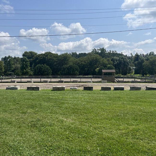 Rectangular fenced in area of dirt.