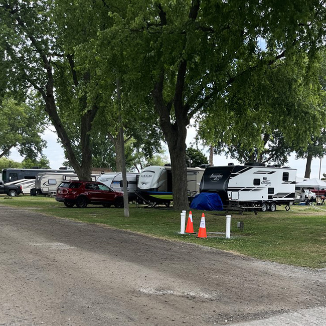 Rows of trailers set up of people camping.