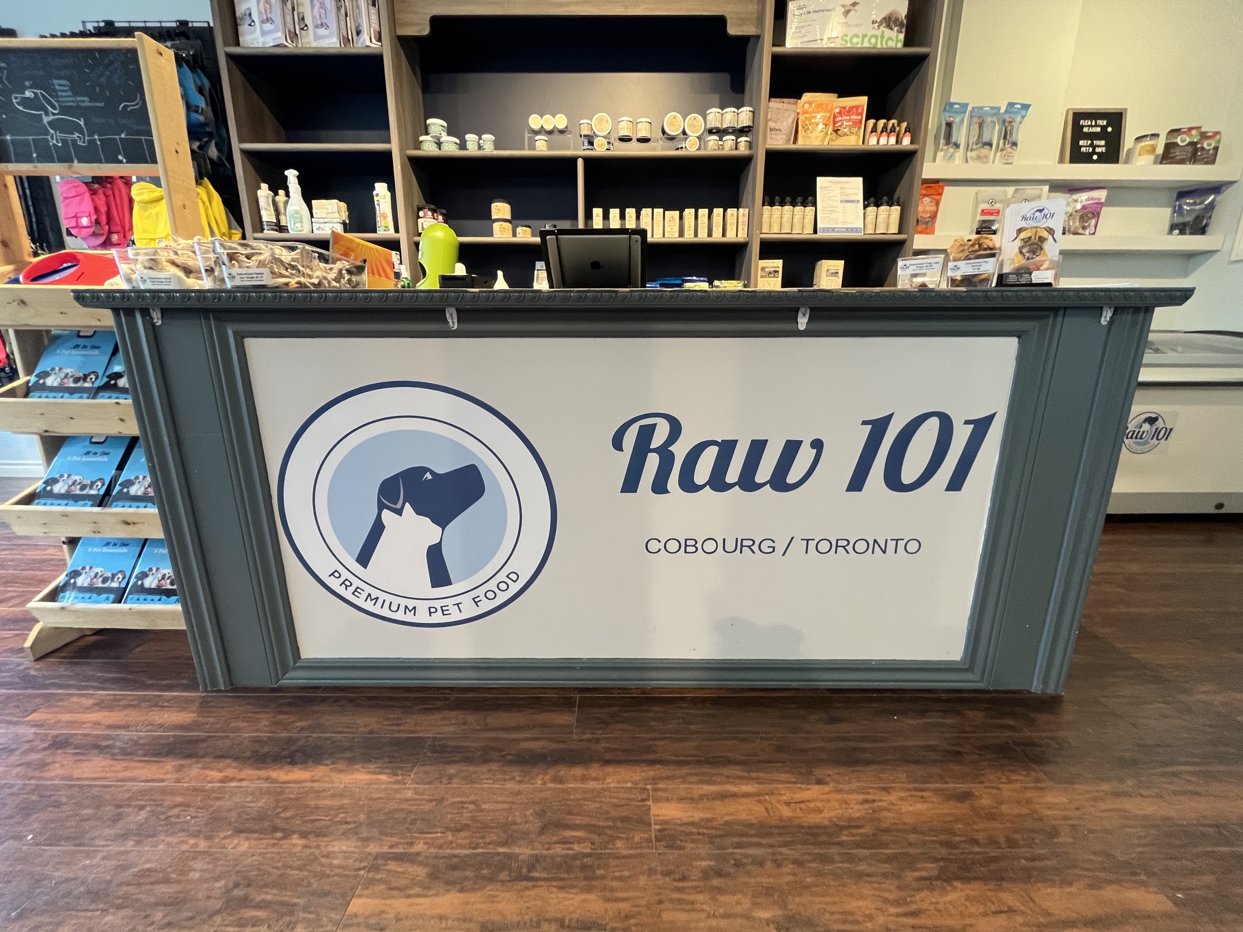 Photo of Raw 101 front counter. Sign reads "Raw 101 Cobourg/ Toronto."