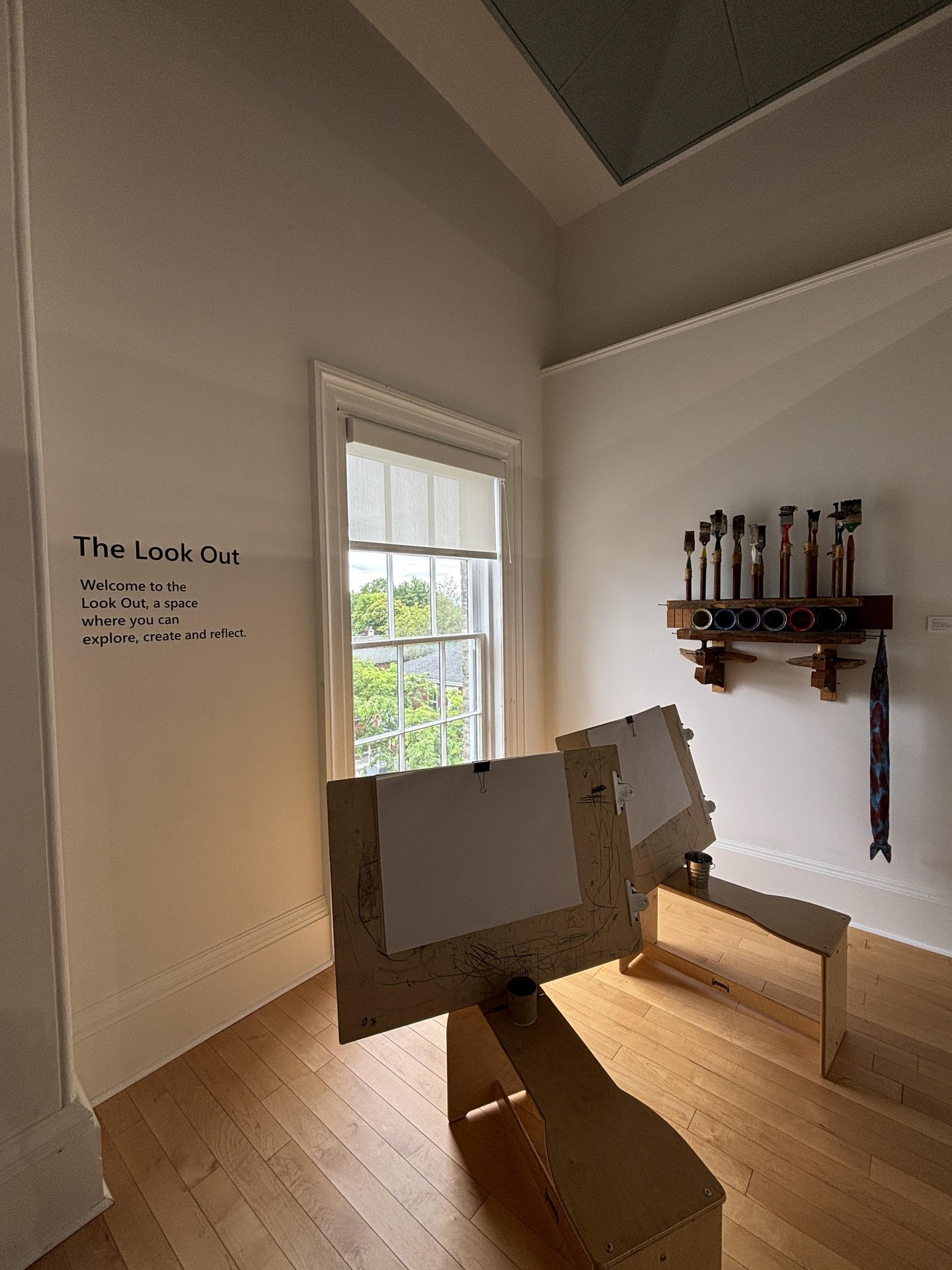 Room at Art Gallery of Northumberland with easels and a window letting in natural light