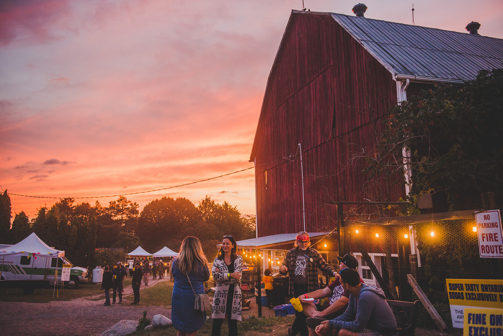Outdoor festival at a barn at dusk