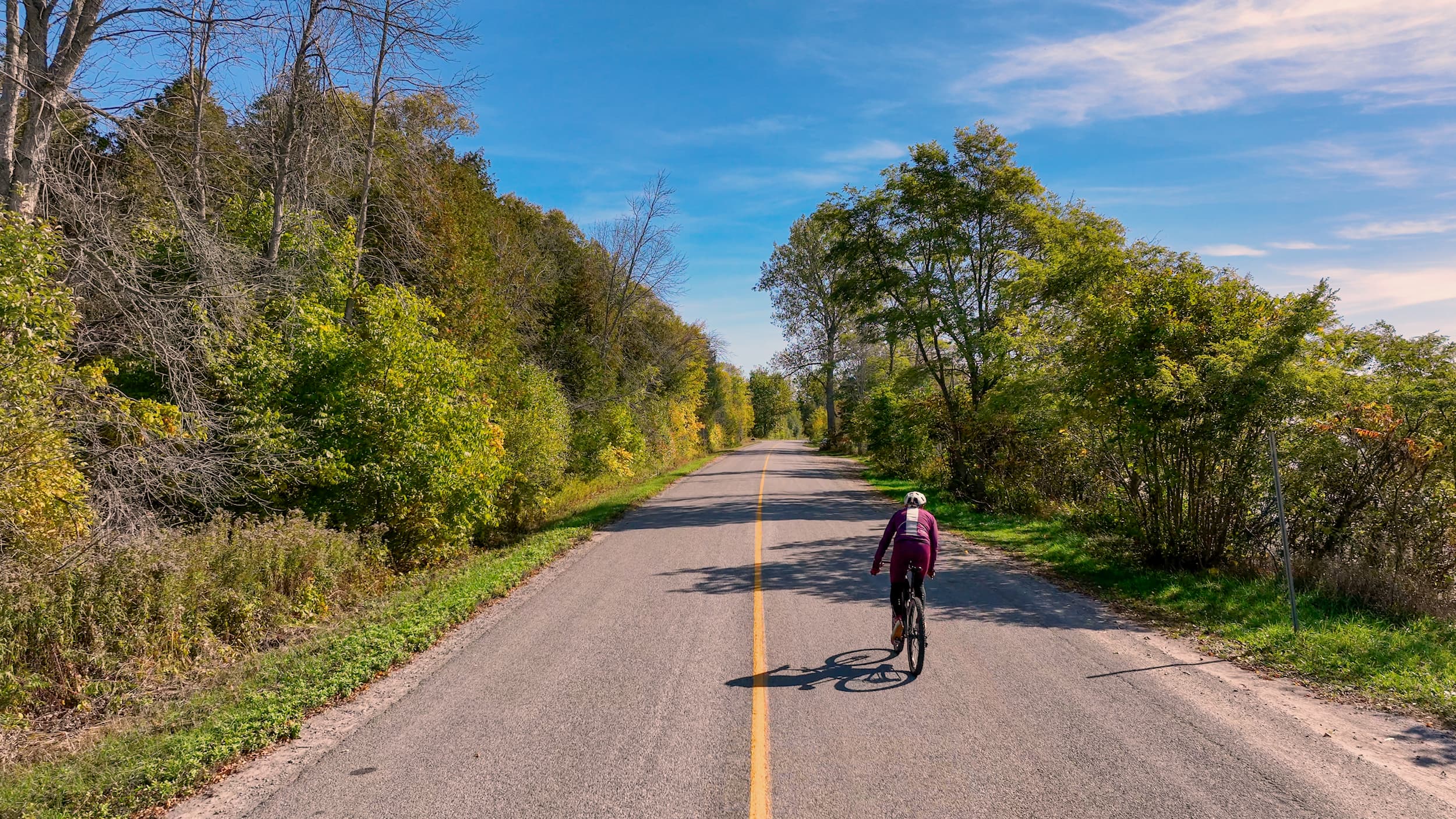Cyclist riding on Wicklow Road in fall