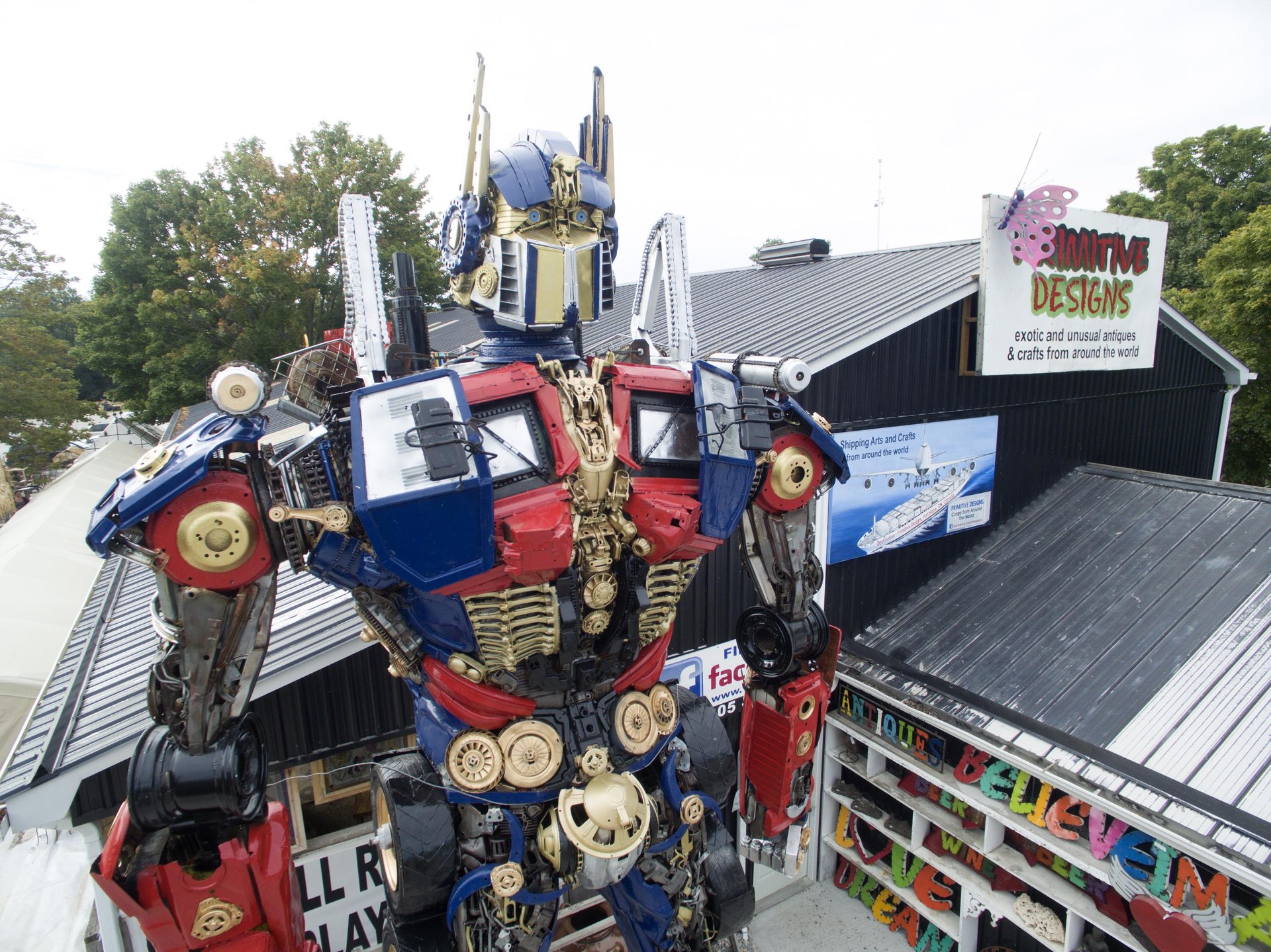 Large robot sculpture in front of Primitive Design