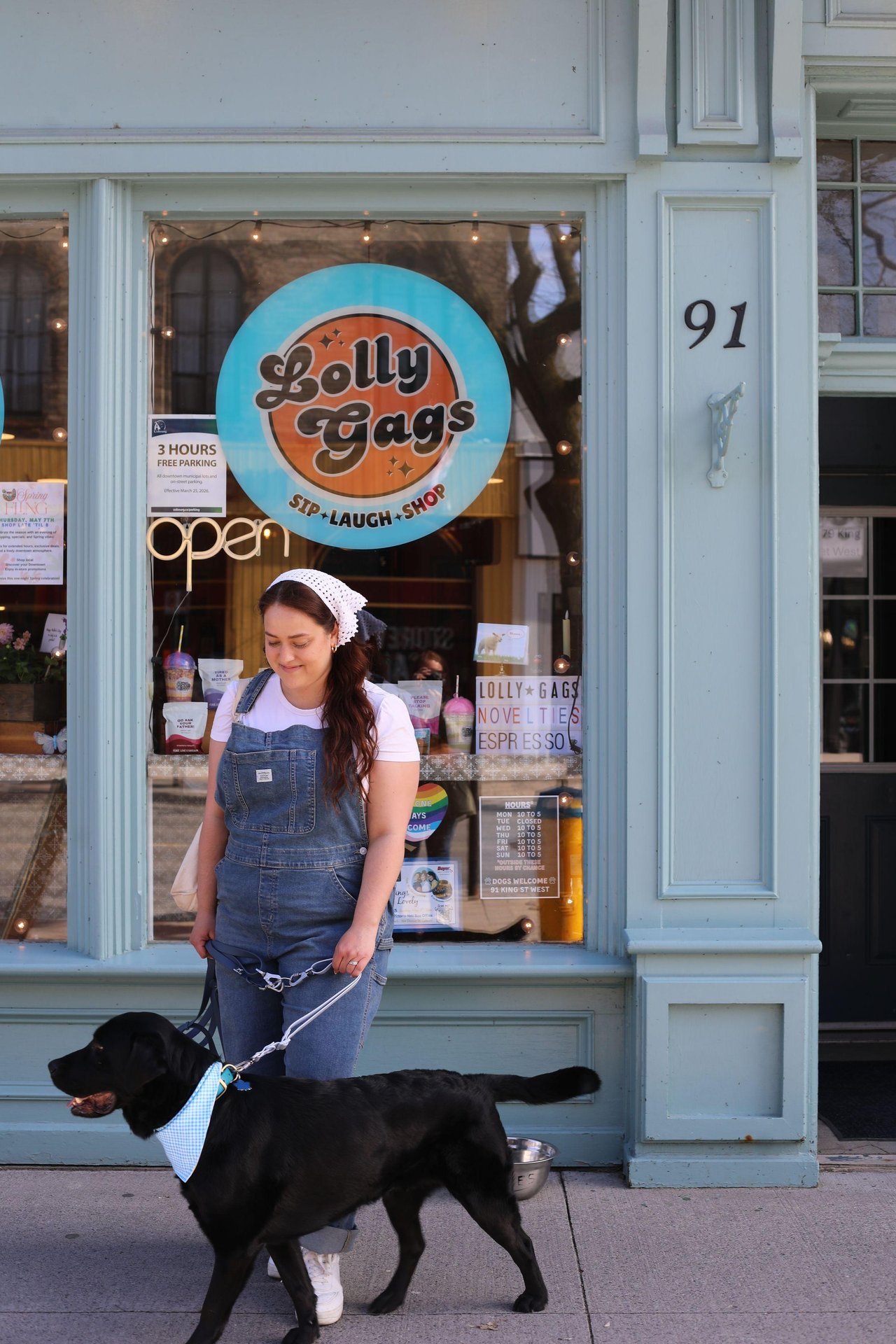 Lolly Gags storefront. Woman walking her dog.