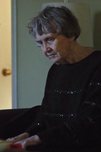 No More Silent Battles. Photo of a senior woman looking downward.