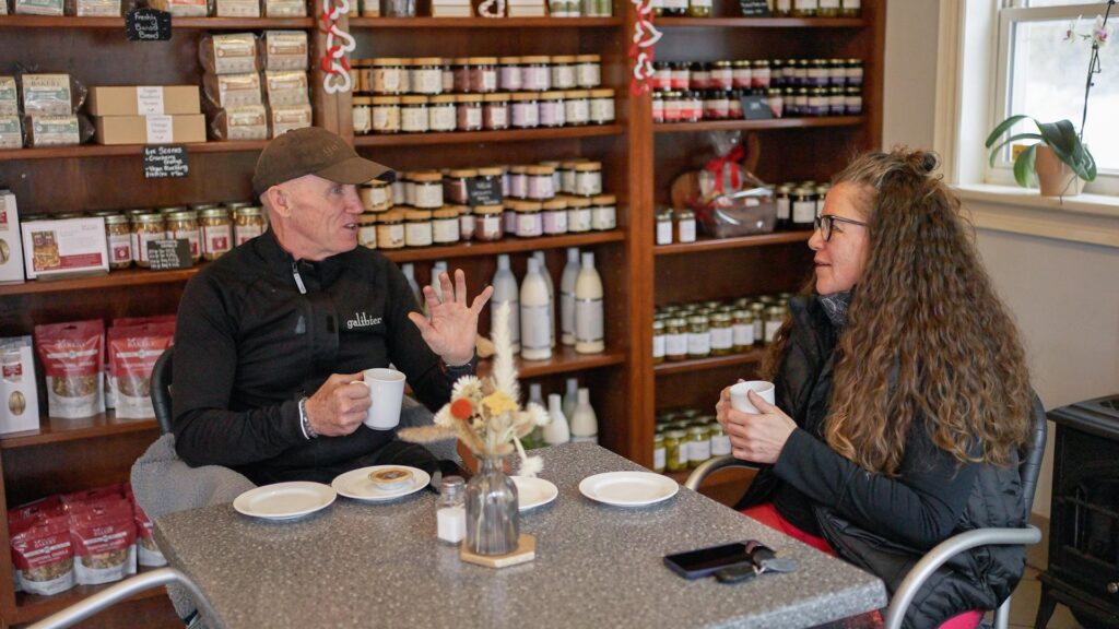 Two people enjoying a snack in a bakery