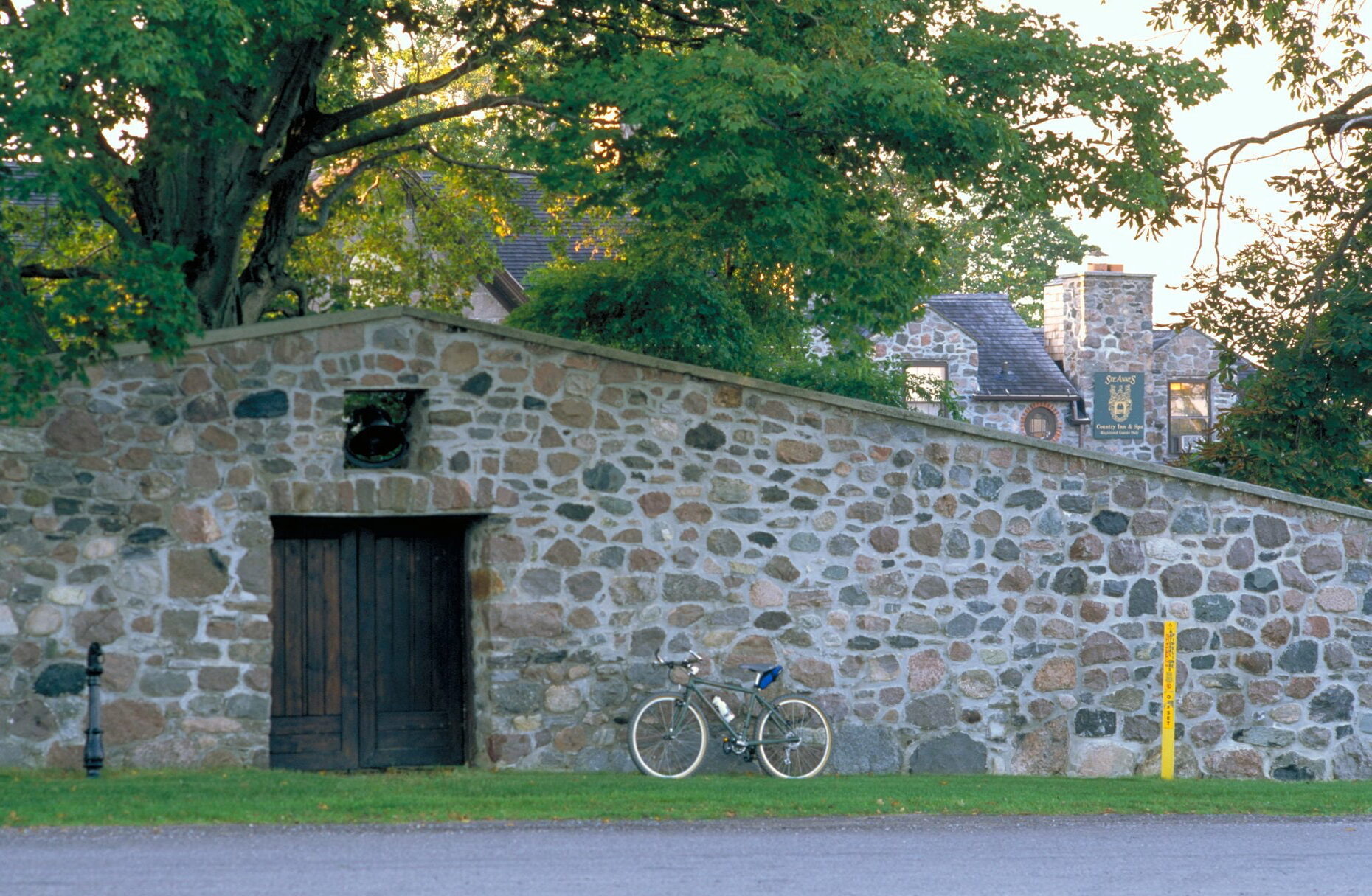 Bike leaning against stone wall at Ste Anne's Spa